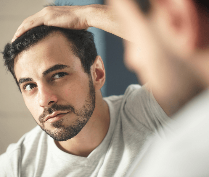 Man looking into mirror
